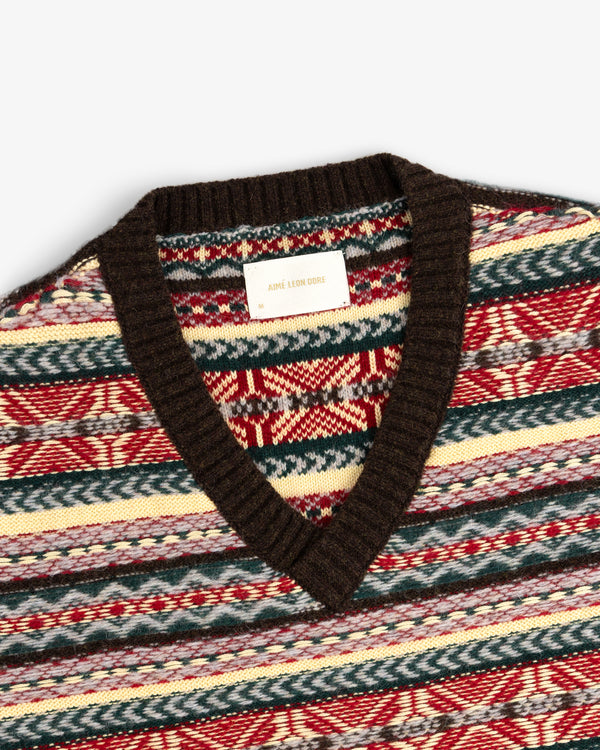Close-up of the Fair Isle V-Neck Sweater, featuring a multicolored knit and brown collar with brand label at the neck.