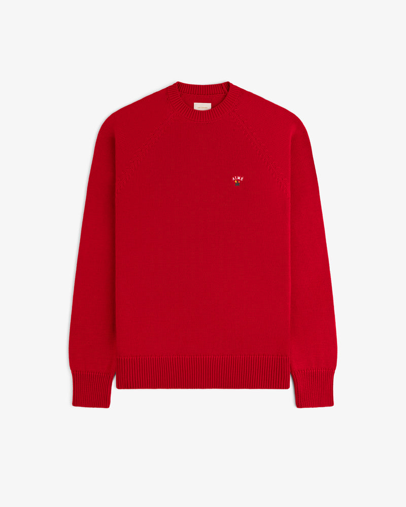 Crest Raglan Sweater: Bright red, long-sleeve knit with ribbed cuffs, hem, and a small left-chest logo.