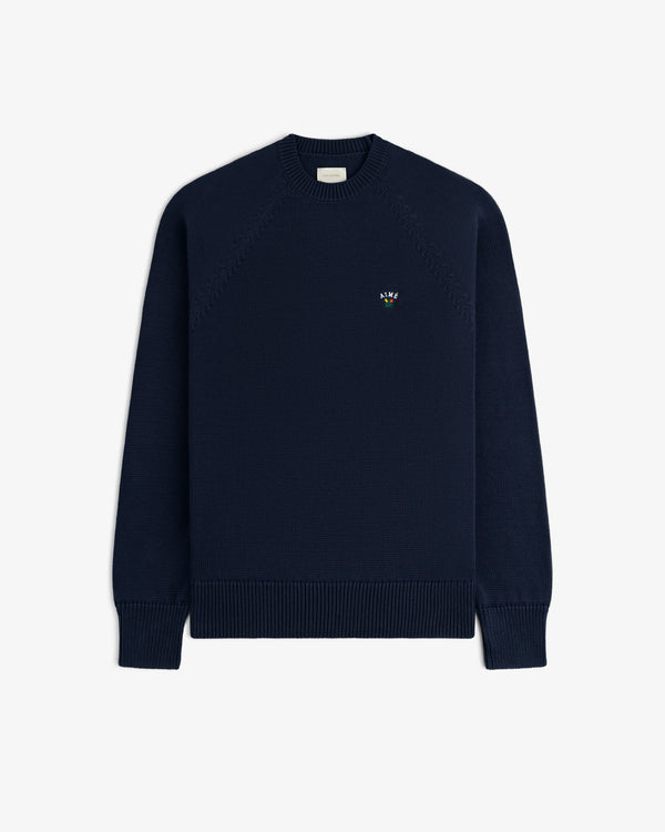 Crest Raglan Sweater: navy crewneck with ribbed cuffs, hem, and an embroidered logo on the left chest.
