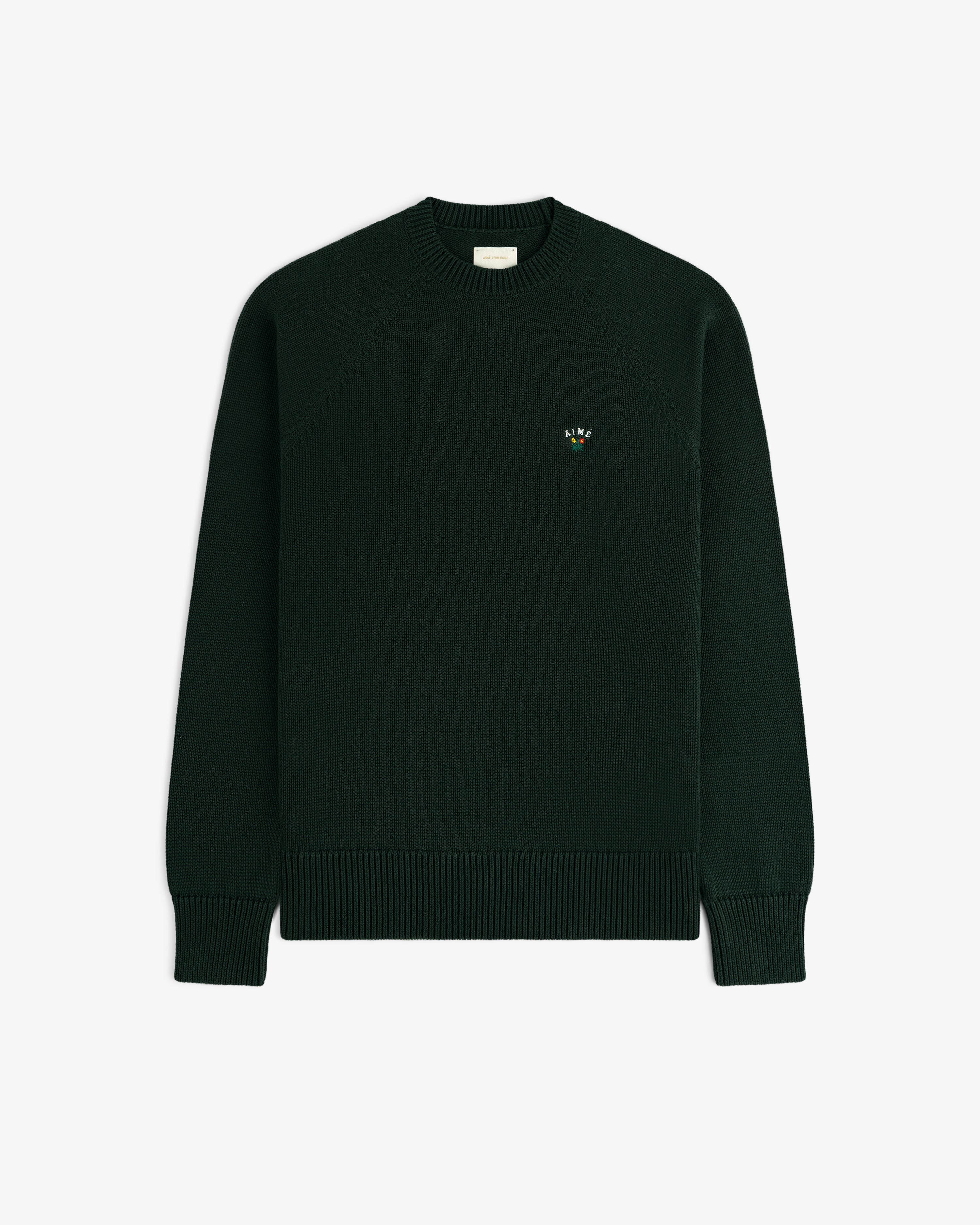 Crest Raglan Sweater—dark green, crewneck, ribbed cuffs/hem, small embroidered logo on left chest.