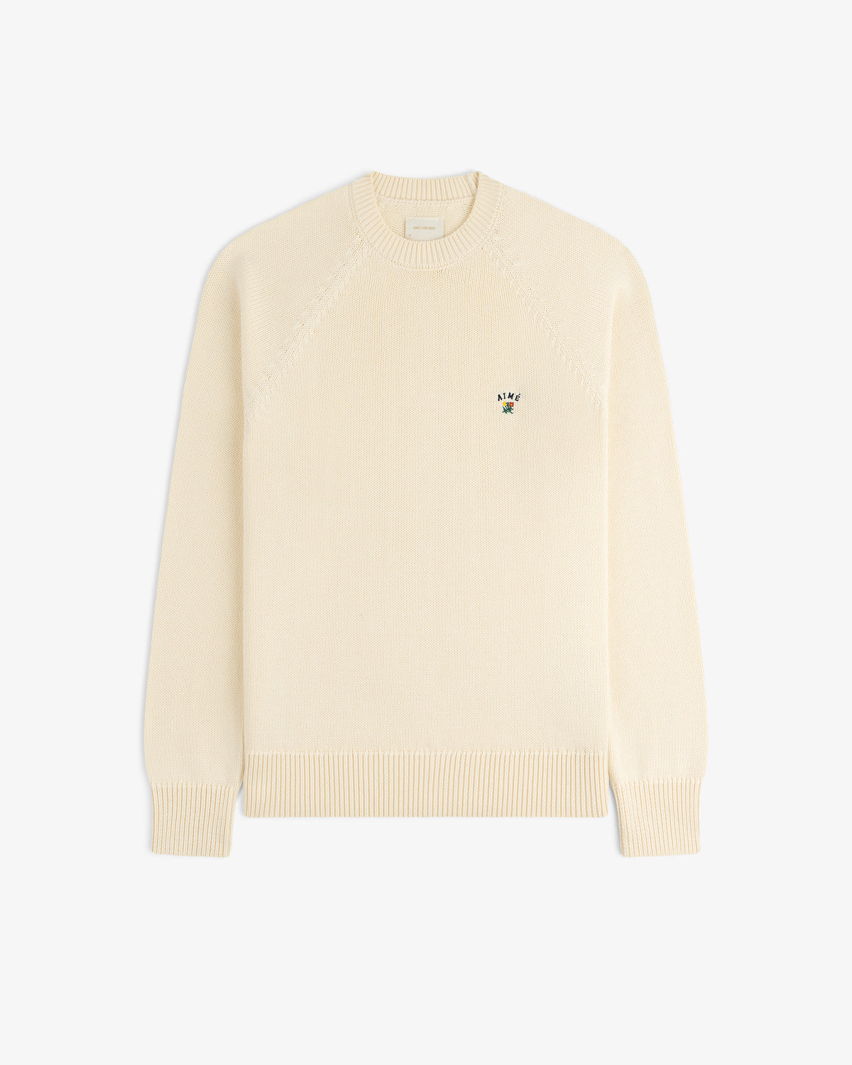Crest Raglan Sweater in cream, long sleeves, small chest logo, displayed flat on a white background.