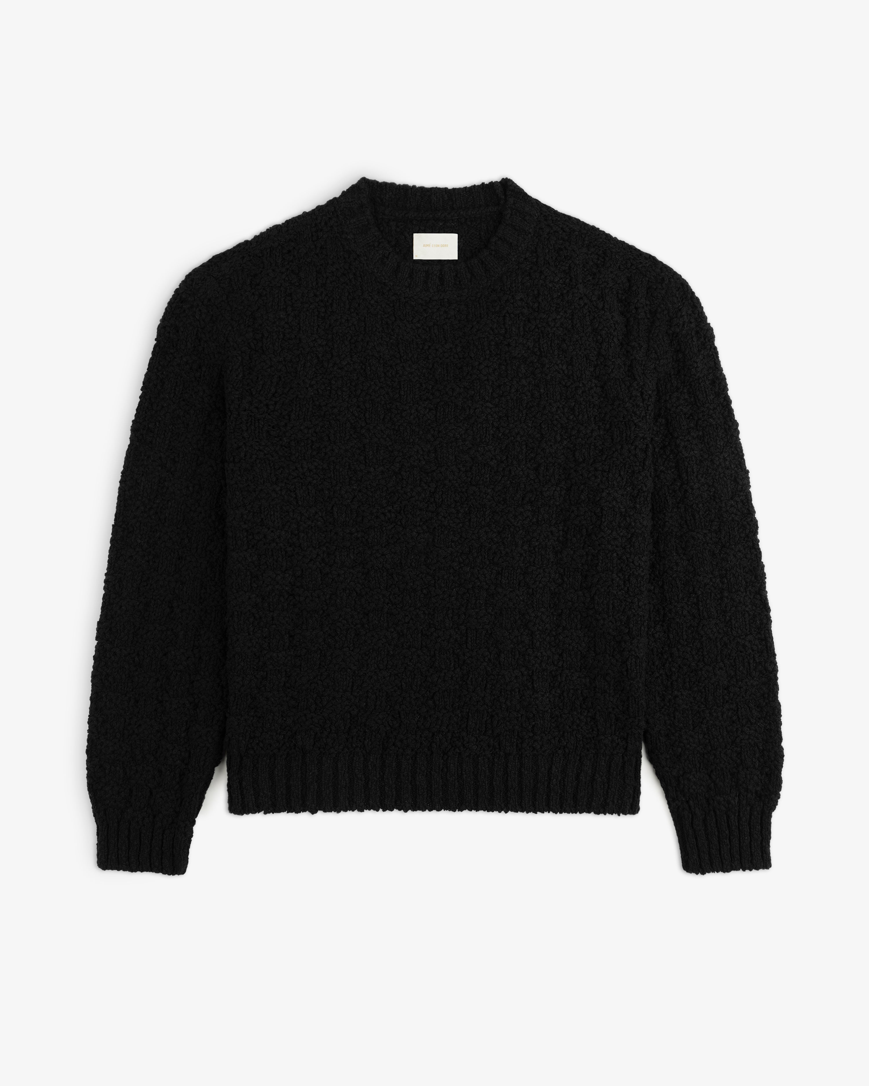 Black Checkerboard Bouclé Sweater with a long-sleeved crewneck and a textured, looped knit pattern.