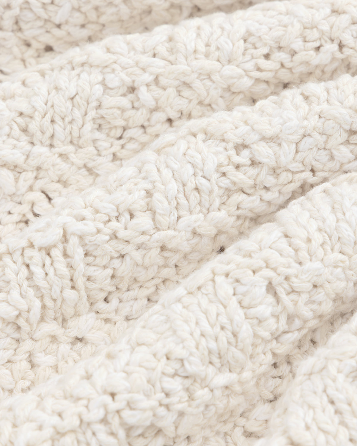 Close-up of the off-white Checkerboard Bouclé Sweater featuring a textured checkerboard pattern.
