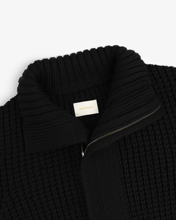 Black Merino Wool Full Zip Sweater with a high ribbed collar and brand label at the neck.