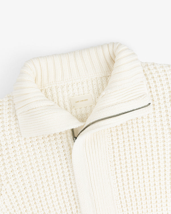 Cream-colored Merino Wool Full Zip Sweater with a ribbed collar and a partial zipper.