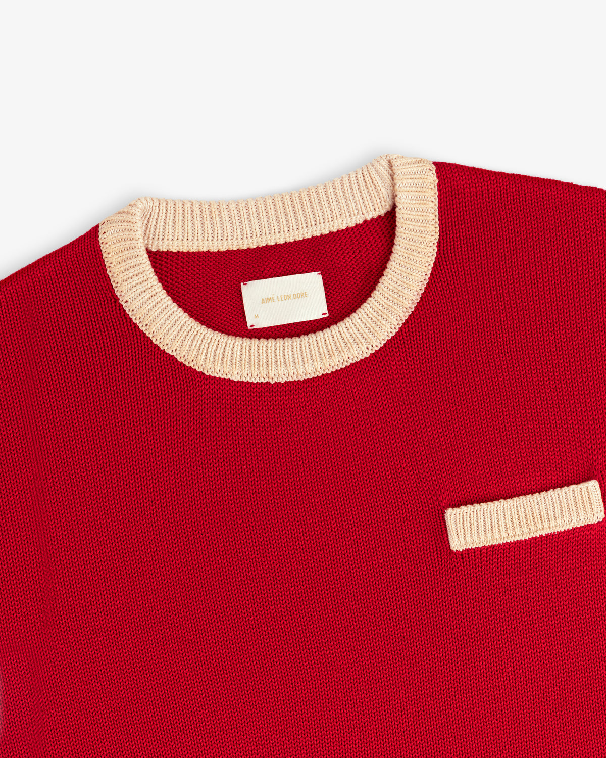 Knit Pocket Crewneck Sweater in red with a contrasting cream ribbed collar and chest pocket.