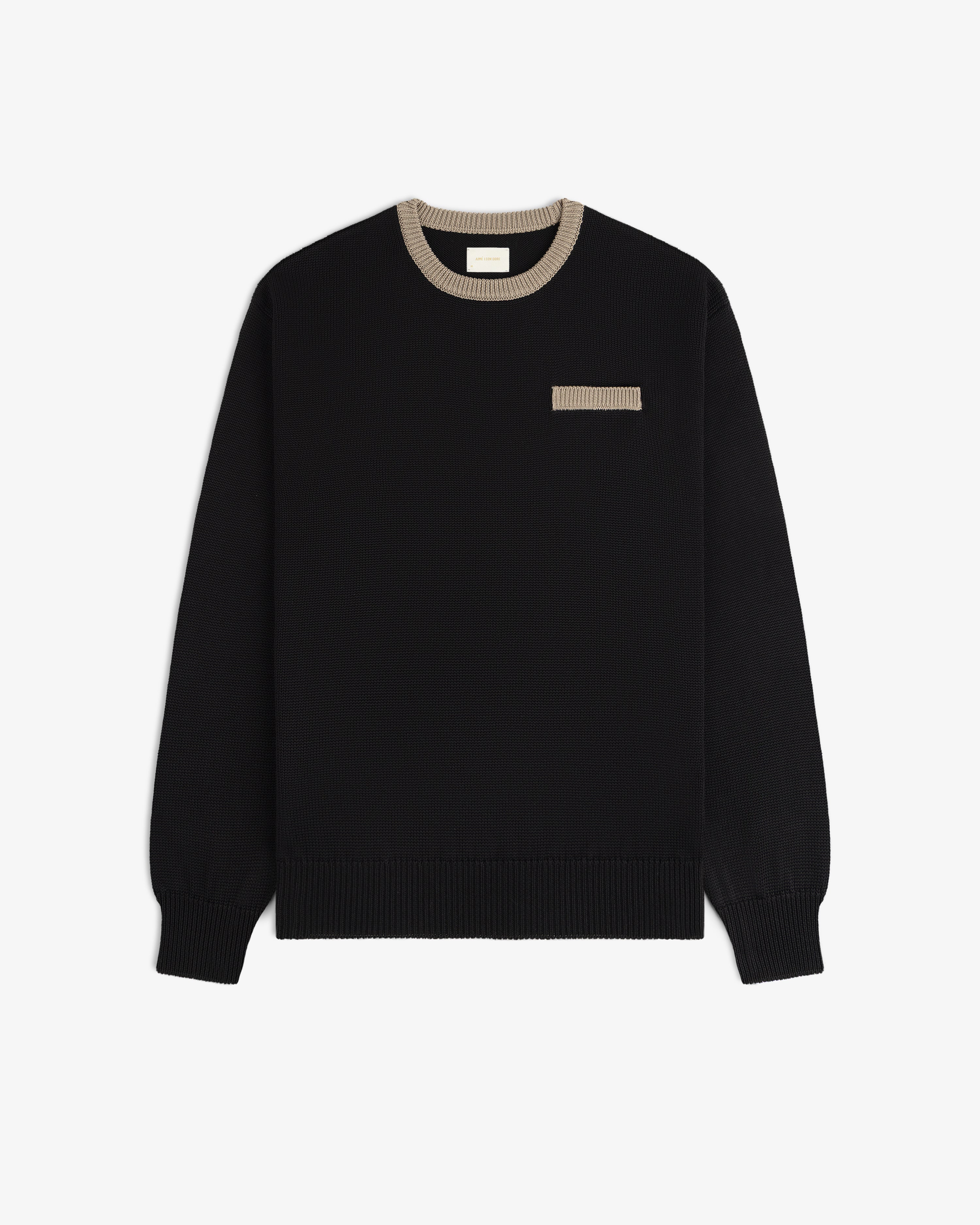 Knit Pocket Crewneck Sweater in black with a contrasting tan ribbed collar and a small matching chest pocket.