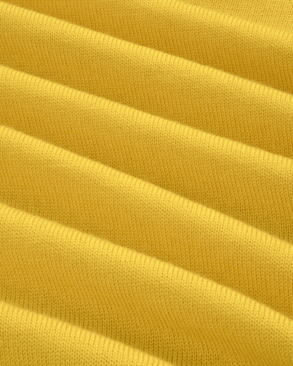 Close-up of yellow Merino Wool Knit Cycling Polo shows ribbed fabric with horizontal ridges and knitted texture.