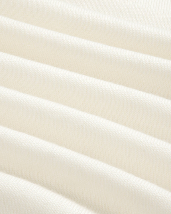 Close-up of soft, white Merino Wool Knit Cycling Polo with horizontal, evenly spaced ribbed texture.