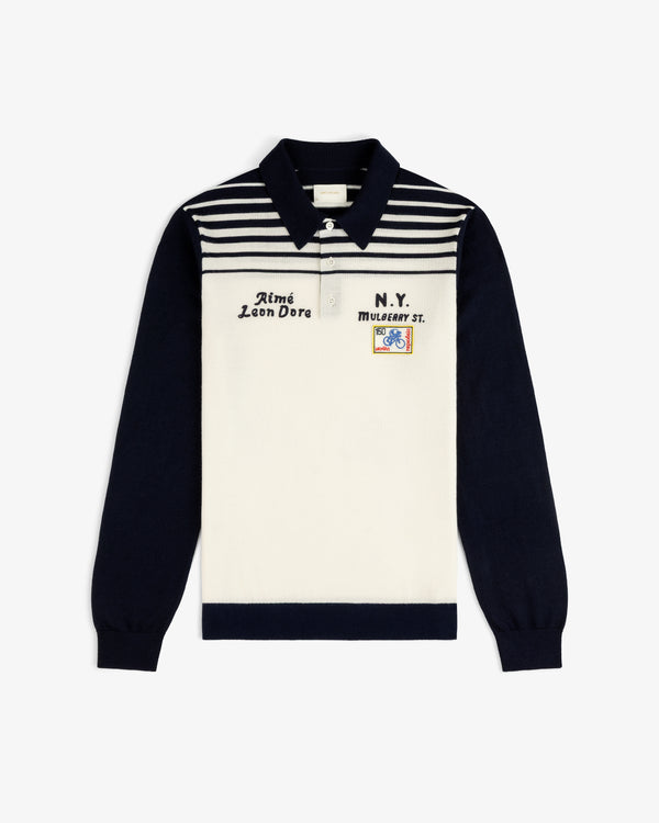 Merino Wool Knit Cycling Polo with navy sleeves, striped front, embroidery, and a colorful patch detail.