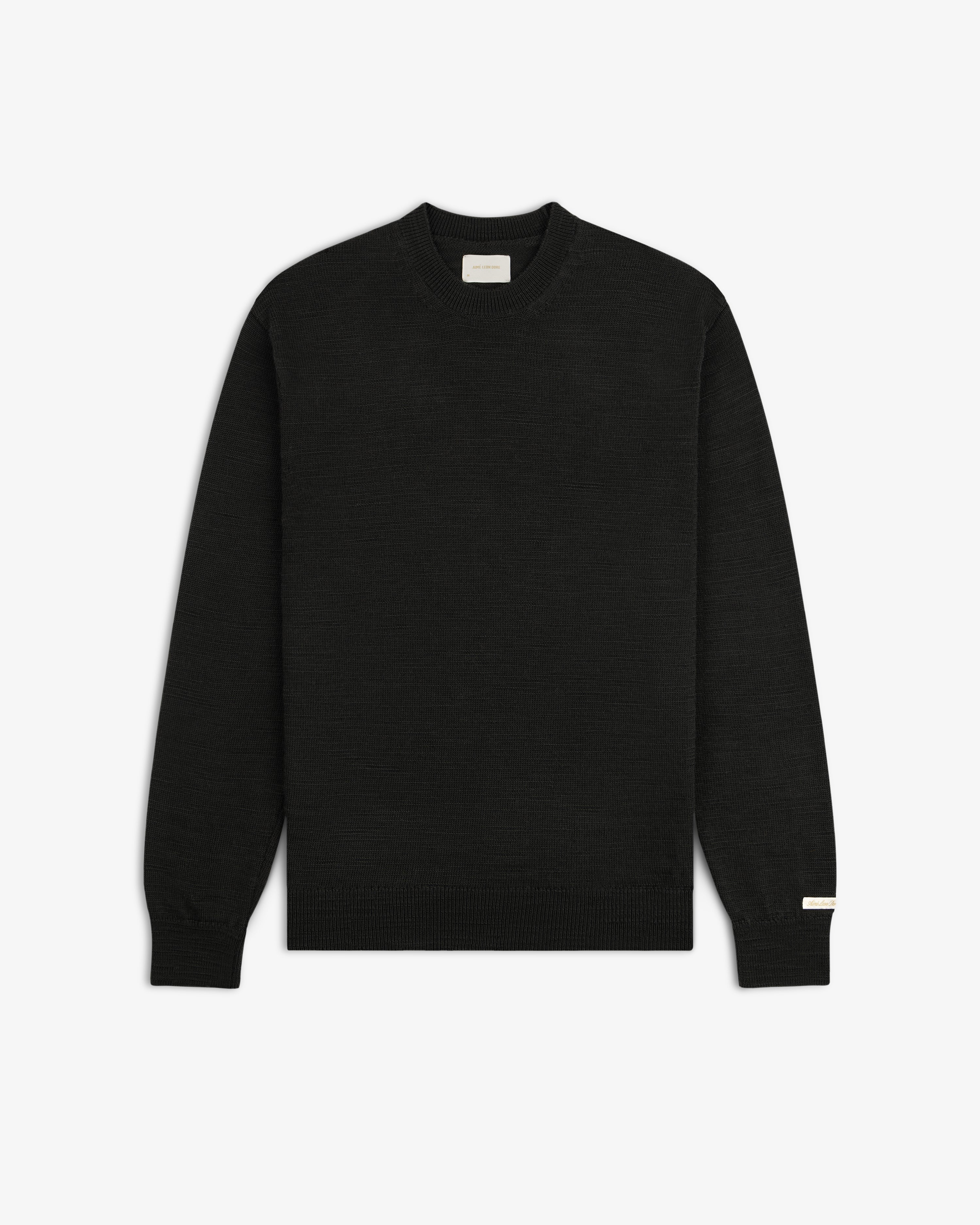 Black Slub Merino Wool sweater with a crewneck, textured knit, and ribbed trim.