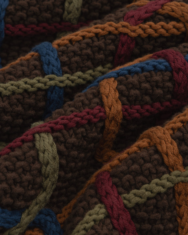 Close-up of a Cable Link Crewneck Sweater in brown with a multicolored cable pattern in blue, green, orange, and maroon.