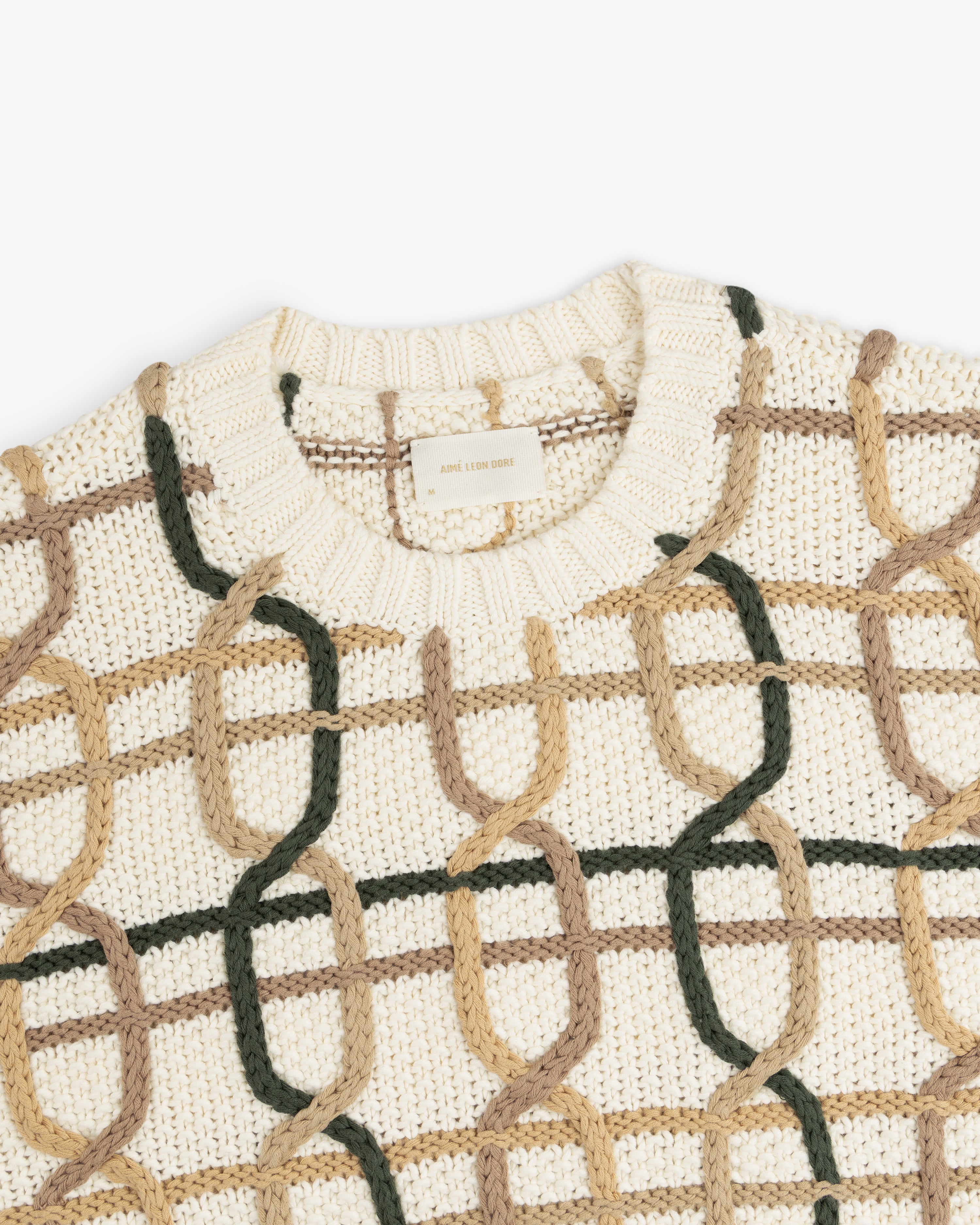 Cable Link Crewneck Sweater in cream with a multicolored dark green and tan chain-link pattern.