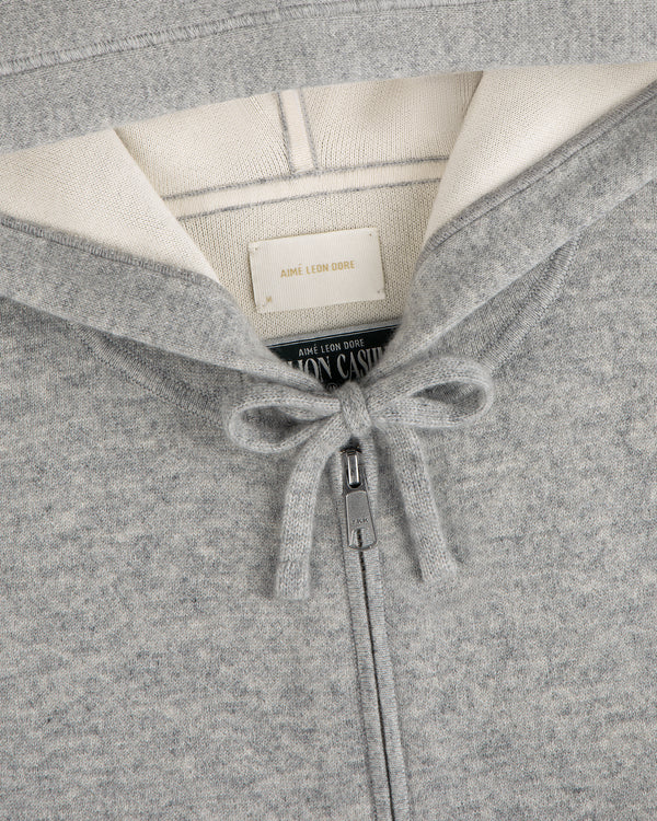 Gray Full-Zip Pavilion Cashmere Hoodie with tied drawstring, cream lining, and Aimé Leon Dore brand label.
