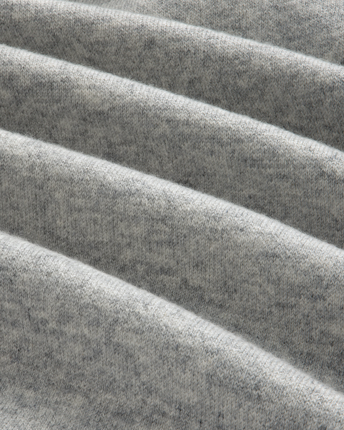 Close-up of folded Full-Zip Pavilion Cashmere Hoodie in light gray, showing its soft texture and visible weave.