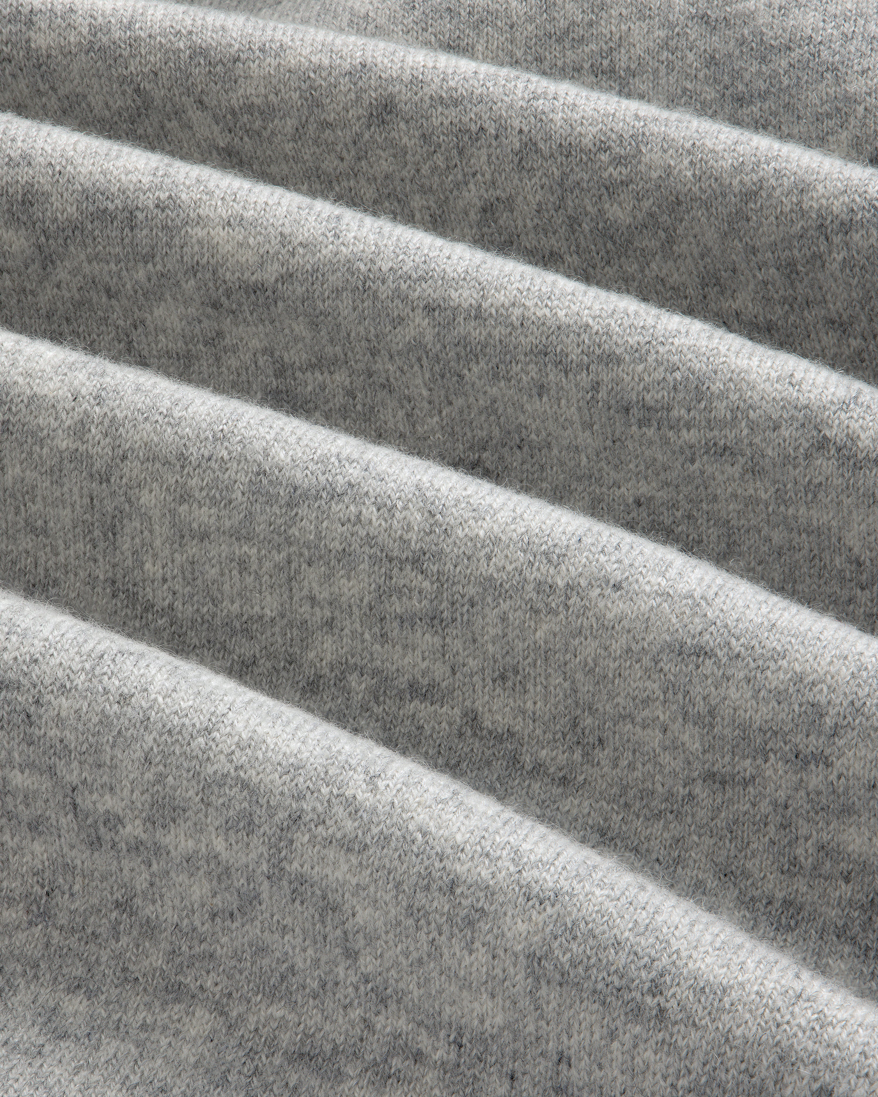 Close-up of soft Pavilion Cashmere Sweatpant in heather gray with evenly spaced horizontal folds.