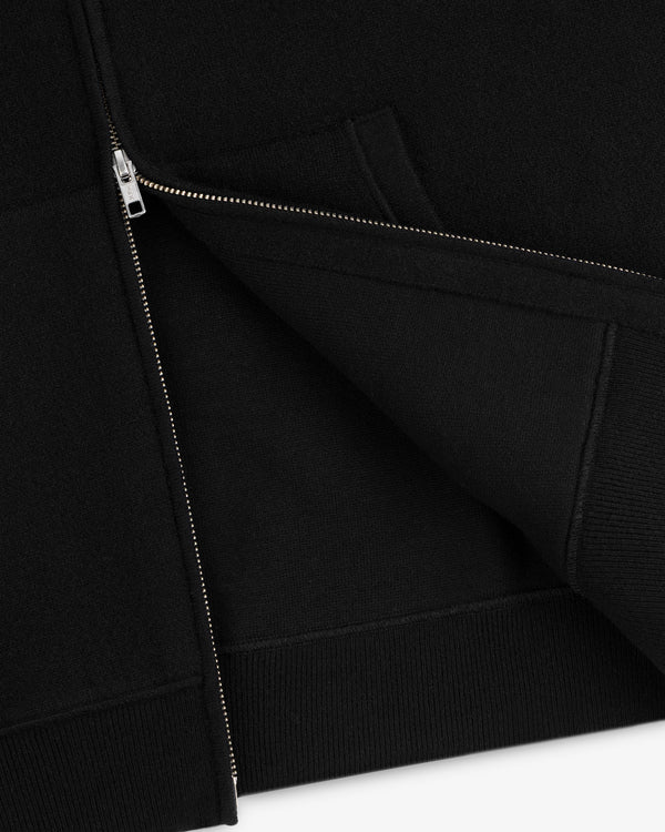 Close-up of a partially unzipped Full-Zip Pavilion Cashmere Hoodie, highlighting the hem and pocket seams.