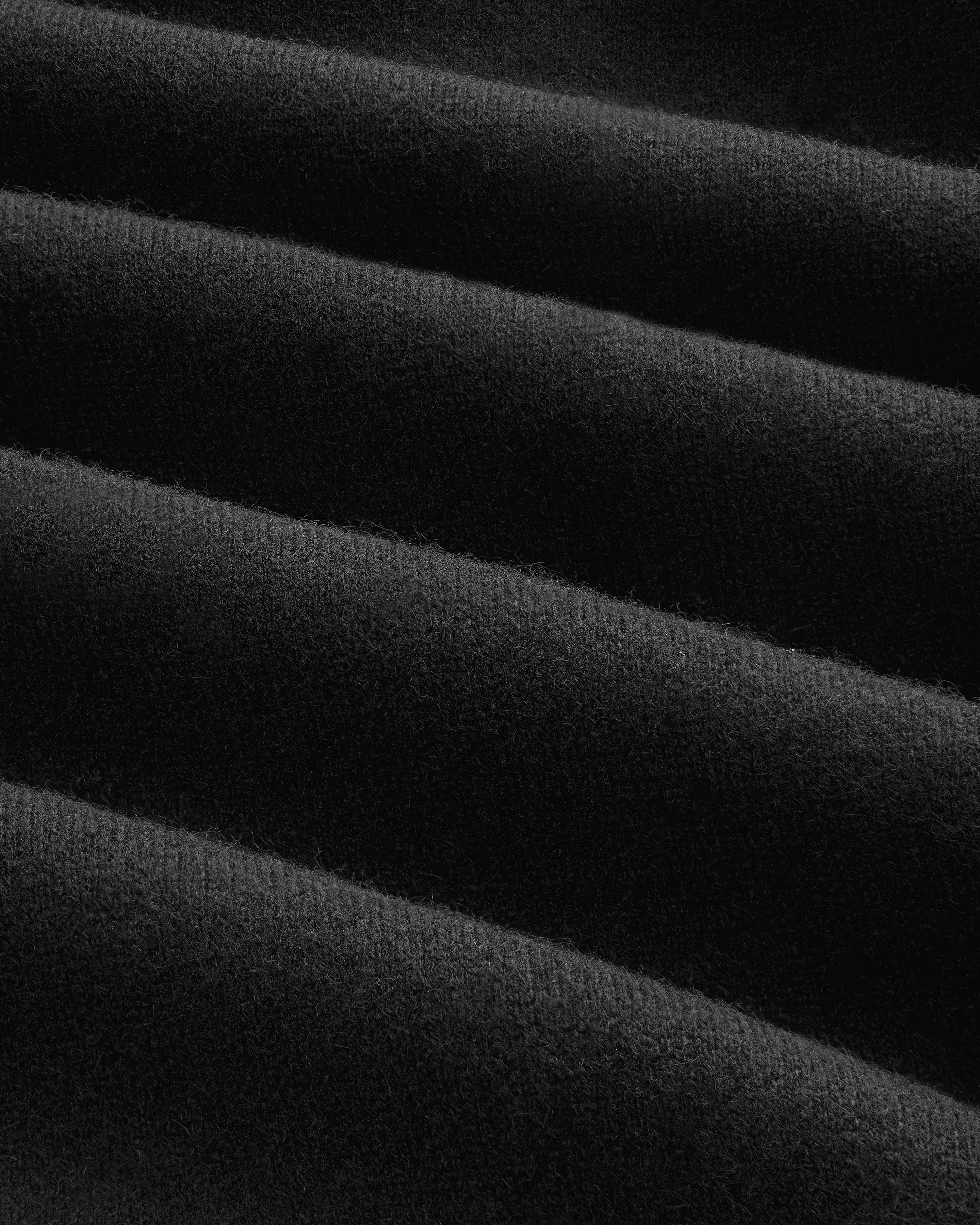 Close-up of Pavilion Cashmere Sweatpant in black, showing ribbed fabric with soft, parallel textured ridges.
