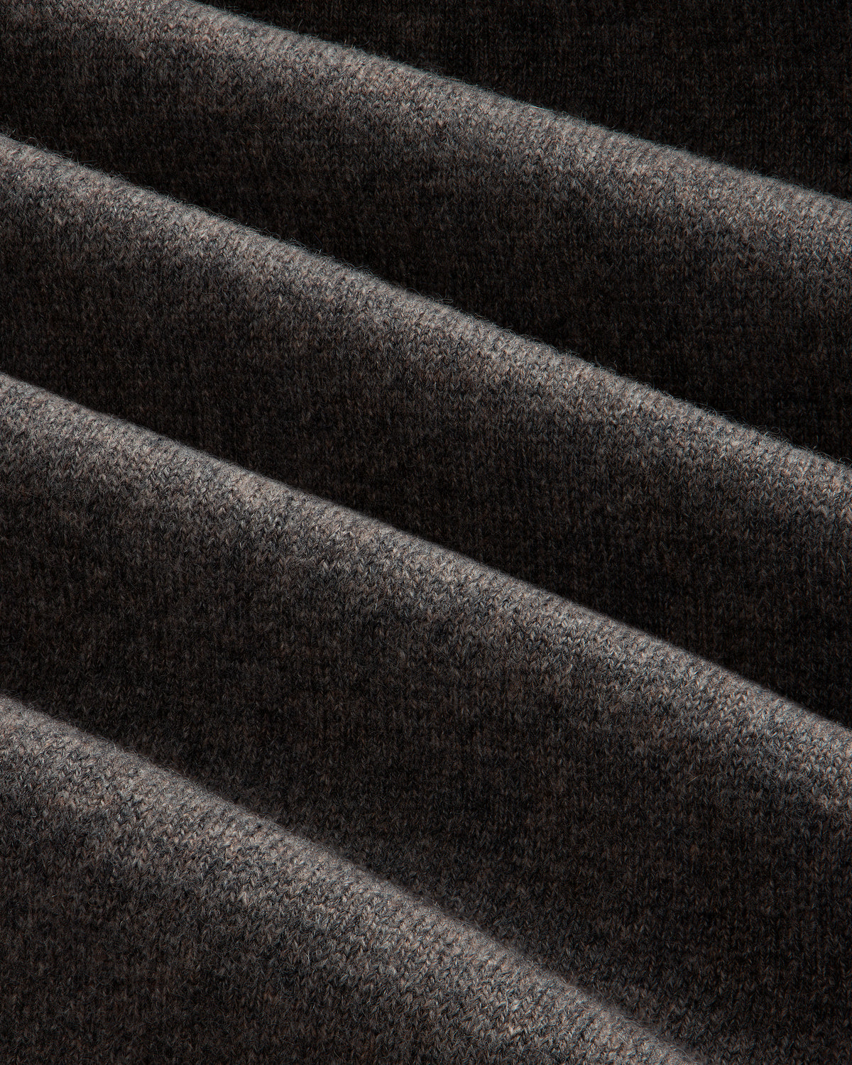 Close-up of the Full-Zip Pavilion Cashmere Hoodie’s dark brown ribbed fabric with soft, visible texture and gentle folds.