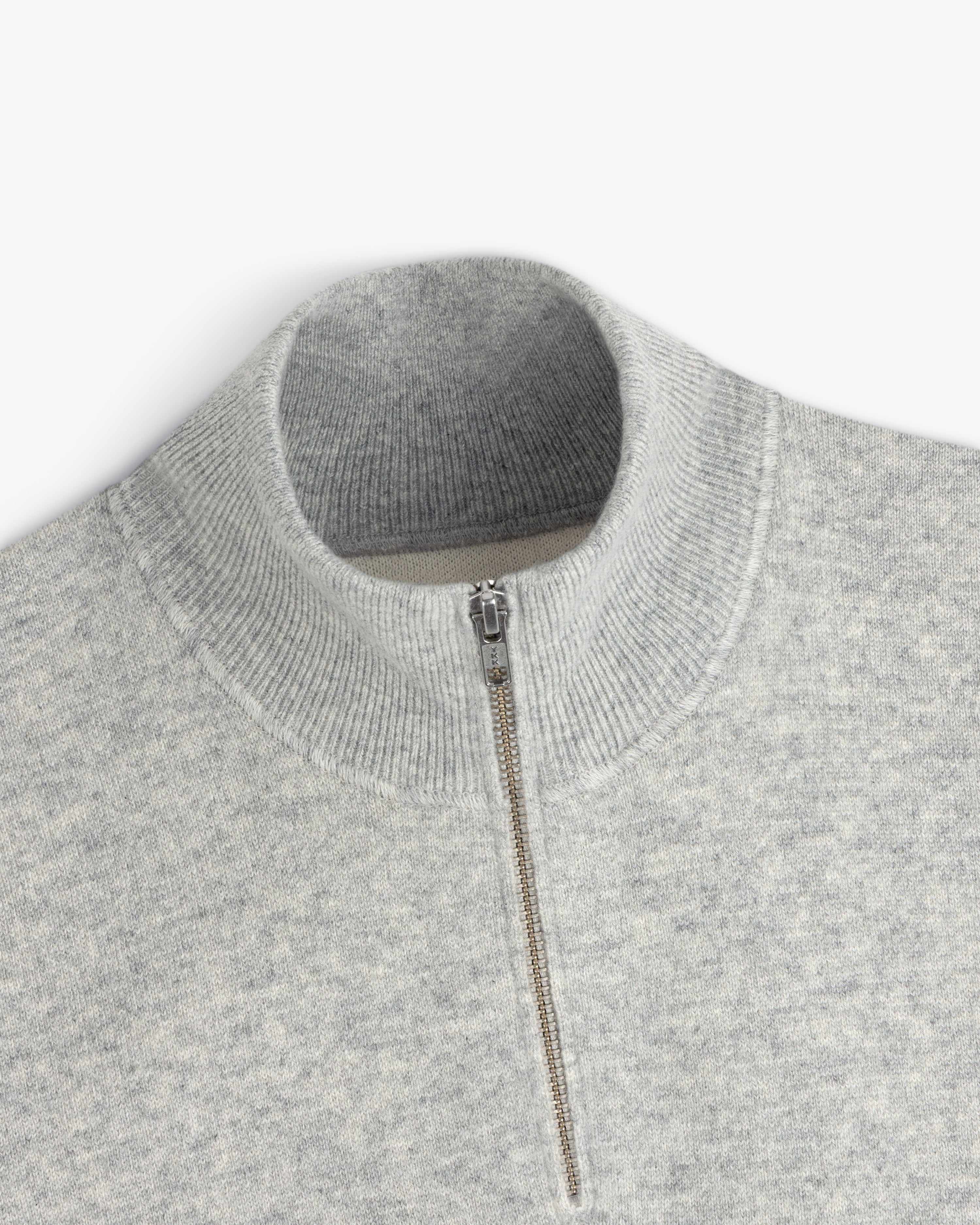 Quarter Zip Pavilion Cashmere Pullover in light gray with ribbed mock neck, shown from a top view.