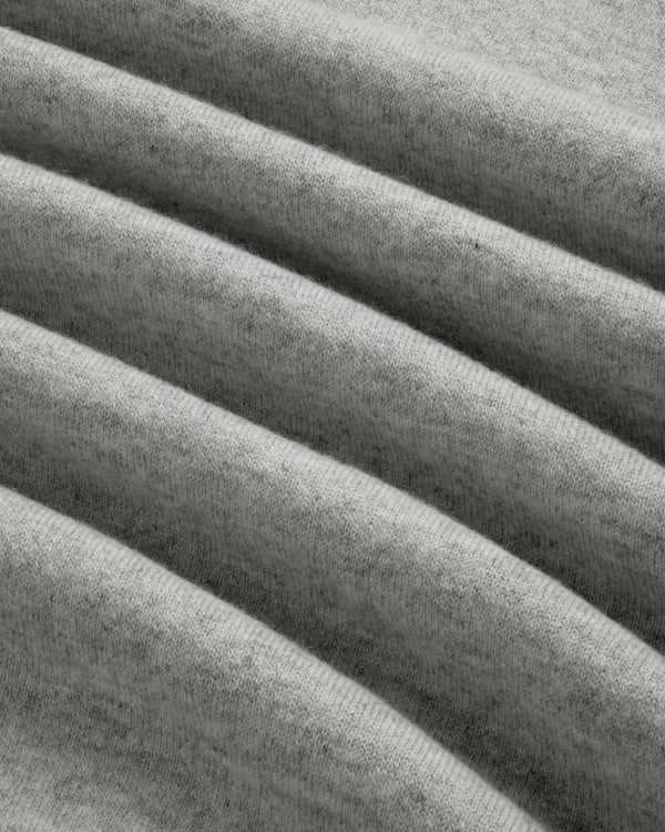 Close-up of grey, ribbed fabric on the Quarter Zip Pavilion Cashmere Pullover, showing its soft, textured pattern.