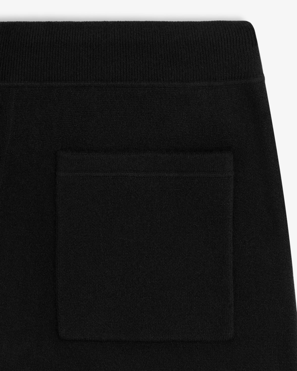 Close-up of Pavilion Cashmere Sweatpant in black with pocket and elastic waistband, shown on white background.