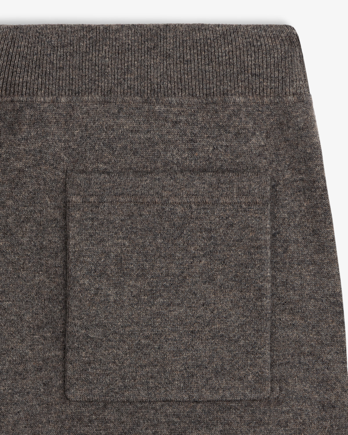 Close-up of a Pavilion Cashmere Sweatpant showing brown knit pocket detail and ribbed waistband above.