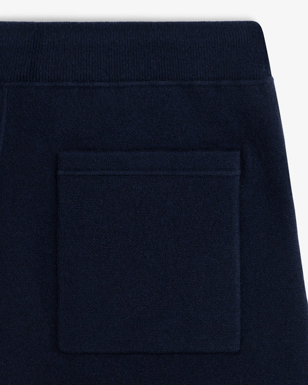 Close-up of Pavilion Cashmere Sweatpant back pocket with ribbed elastic waistband in dark navy blue.