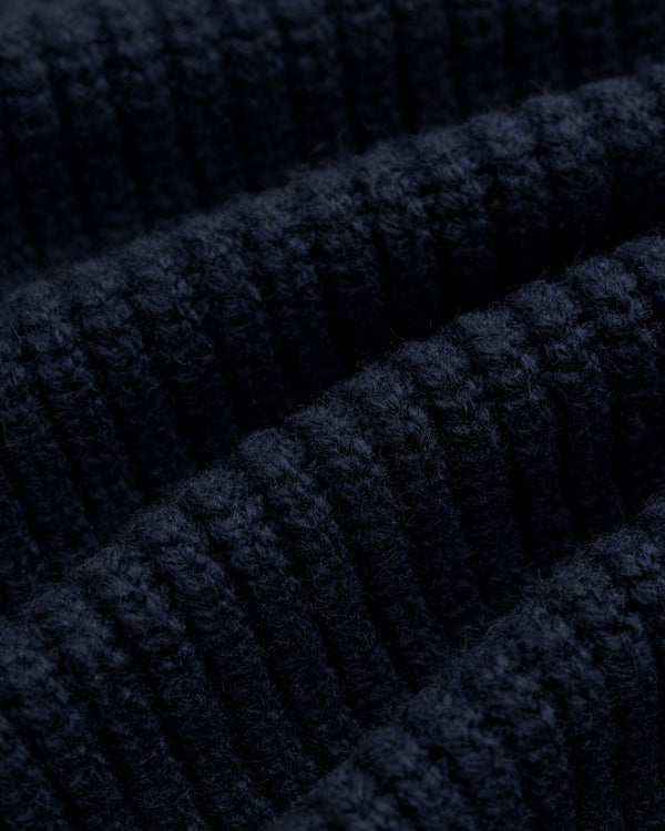 Close-up of NY Highlanders Ribbed Wool Crewneck Sweater, showing textured dark blue knit and soft wool fibers.