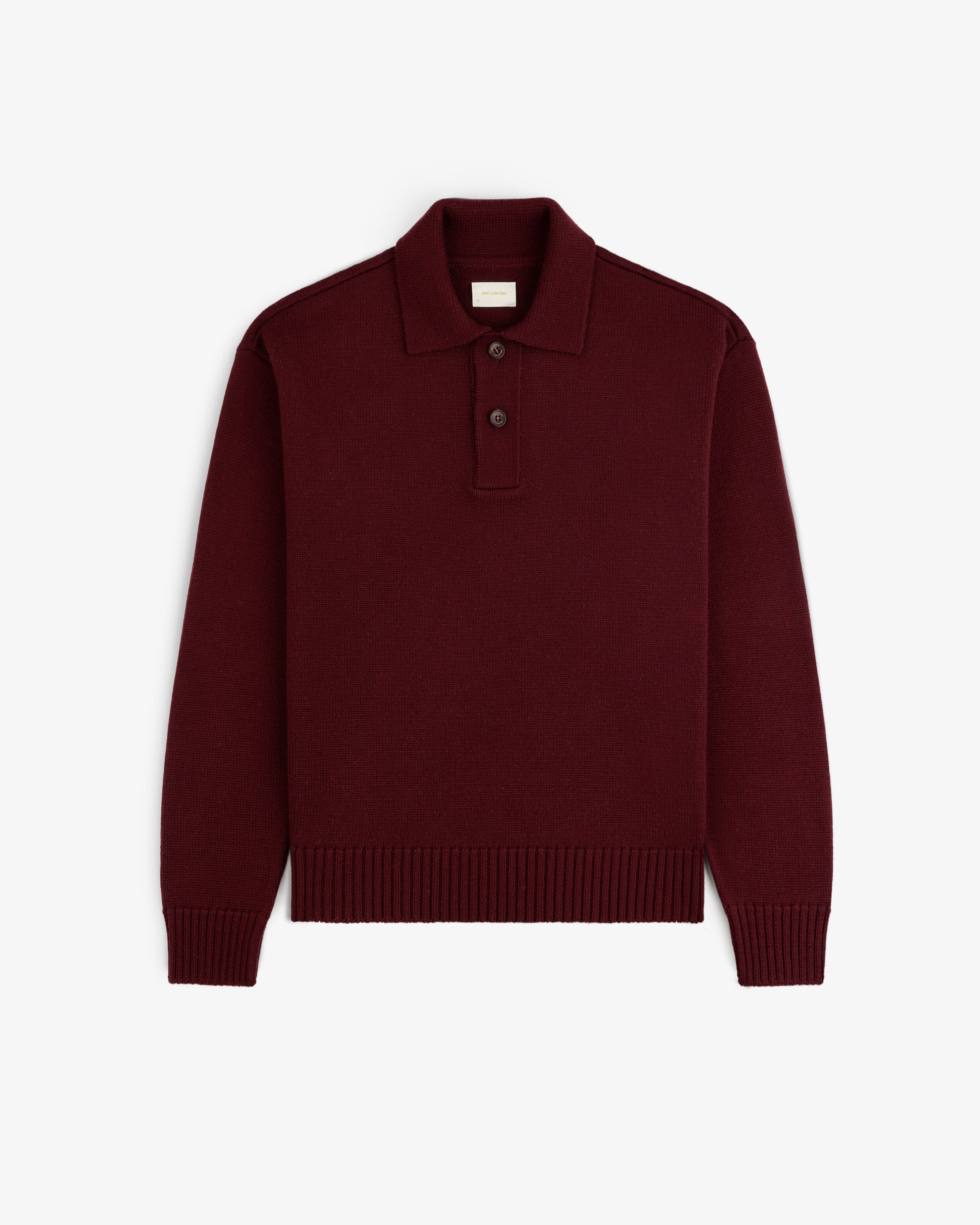Deep red Long-Sleeve Merino Polo shirt featuring a knit texture and a button placket.