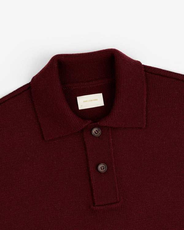 Close-up of a burgundy Long-Sleeve Merino Polo featuring a collar and two dark buttons.