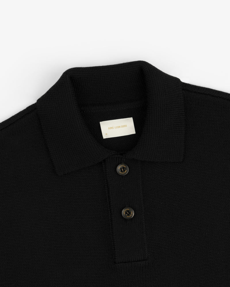 Black Long-Sleeve Merino Polo with a collared neckline and a two-button placket.