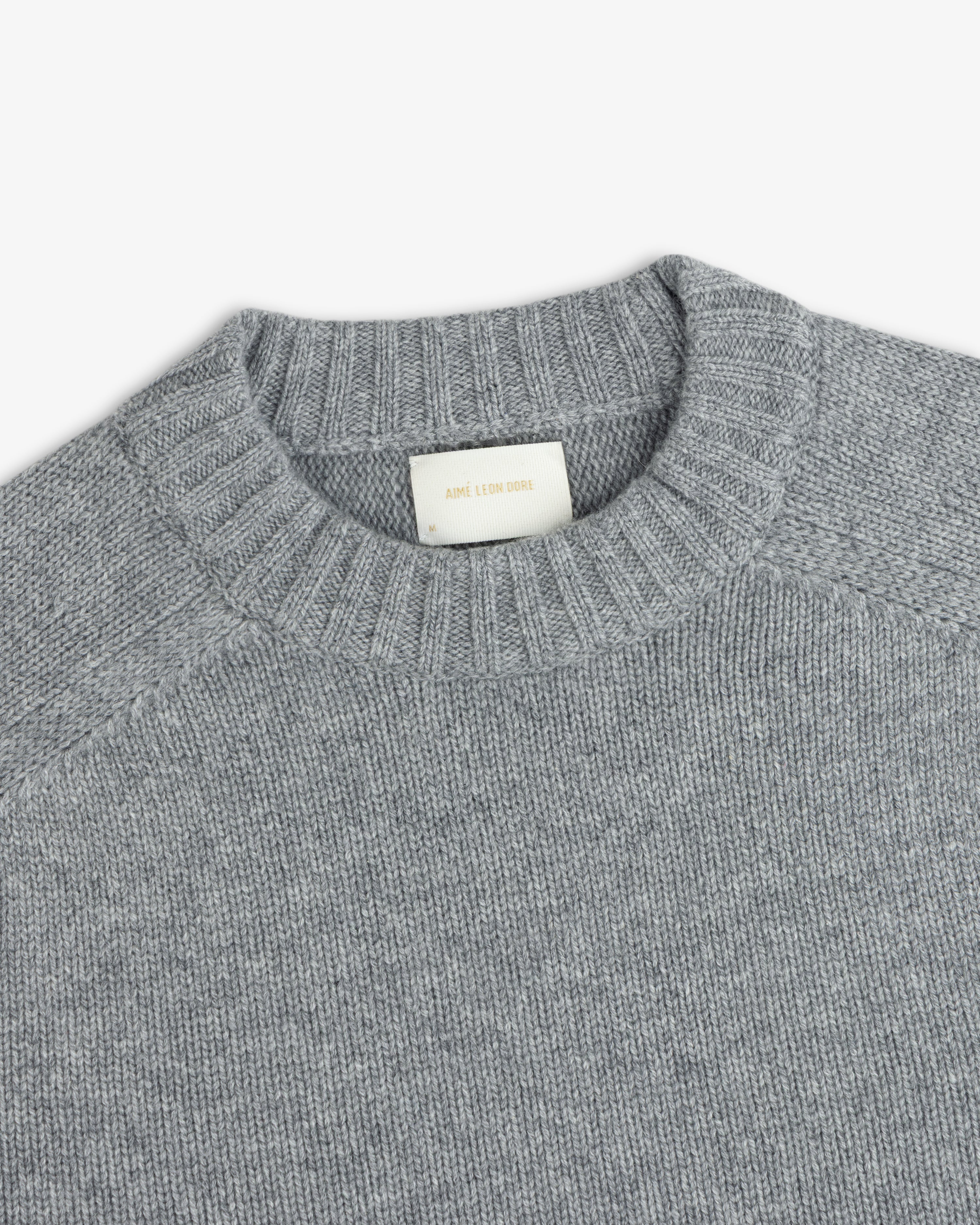 Grey Cashmere Crewneck Sweater with a ribbed collar and an interior brand label.