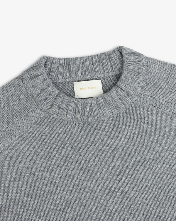 Grey Cashmere Crewneck Sweater with a ribbed collar and an interior brand label.