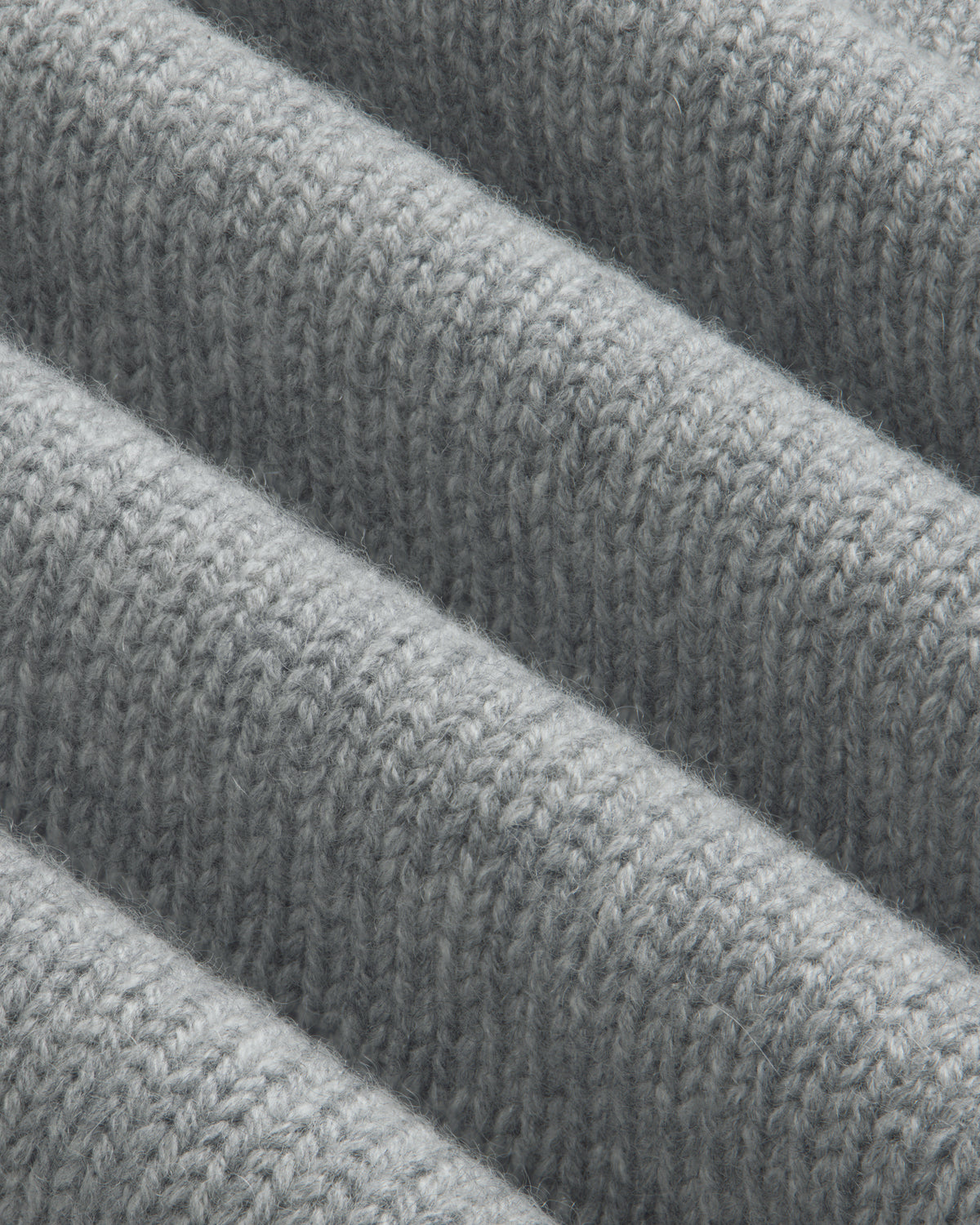 Close-up of a grey Cashmere Crewneck Sweater with ribbed texture.