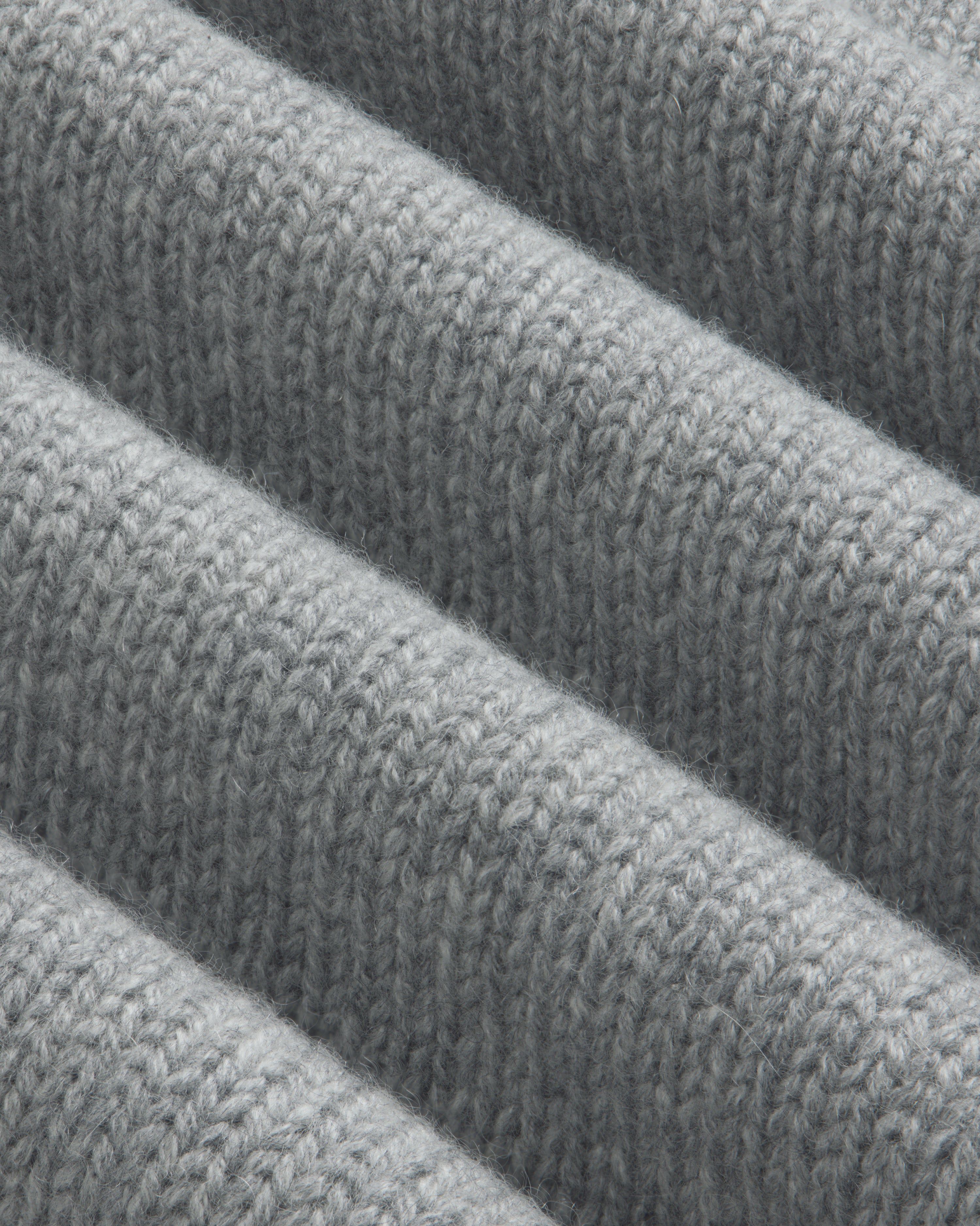 Close-up of a grey Cashmere Crewneck Sweater with ribbed texture.