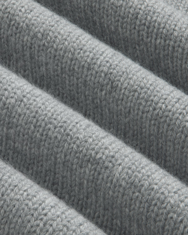 Close-up of a grey Cashmere Crewneck Sweater with ribbed texture.