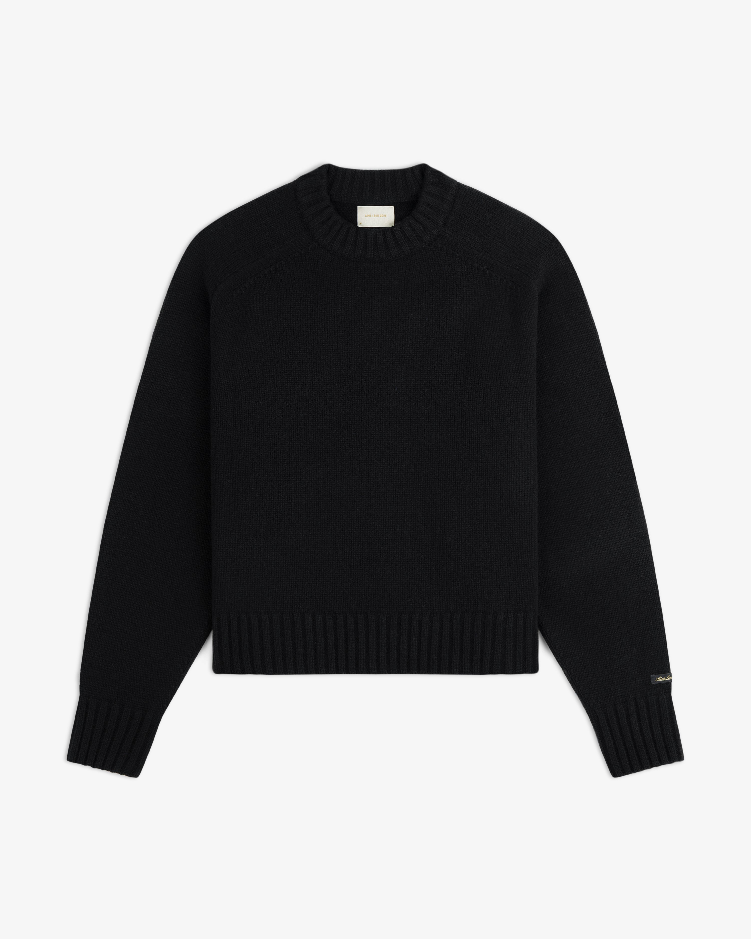 Black Cashmere Crewneck sweater with a long-sleeve design and a ribbed hem and cuffs.