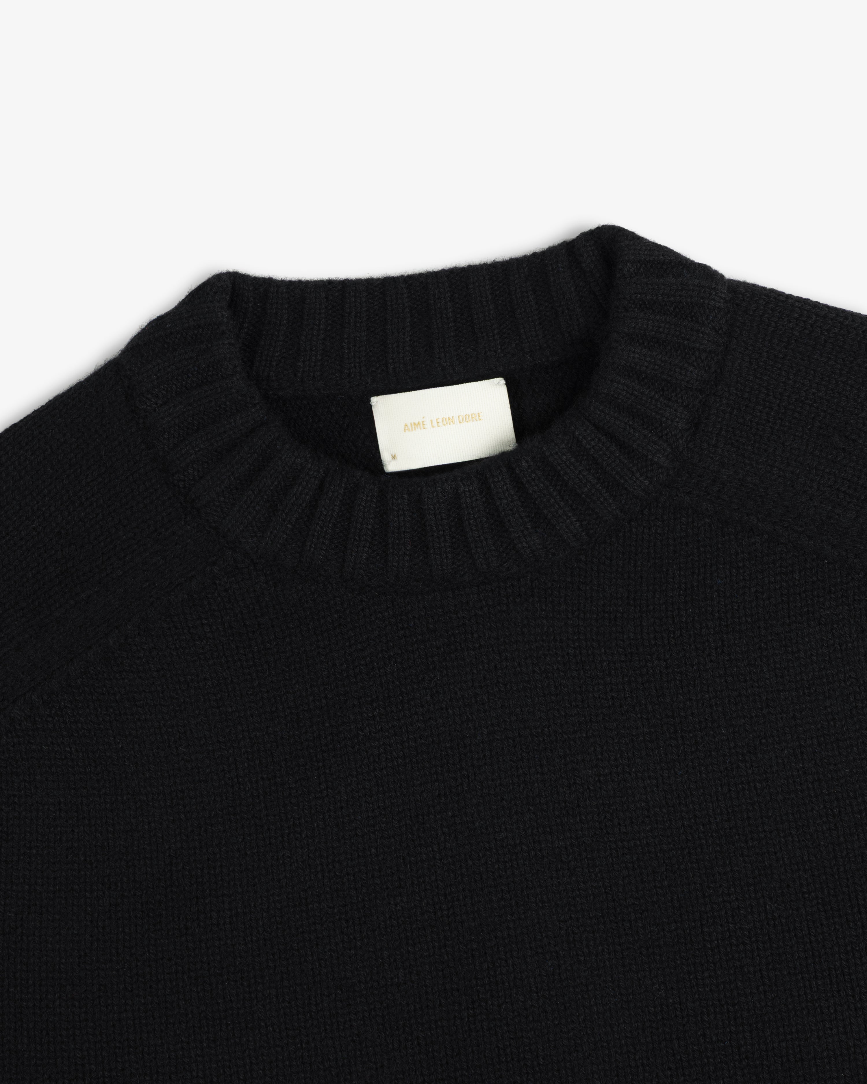 Black Cashmere Crewneck Sweater with a ribbed collar and an interior brand label.