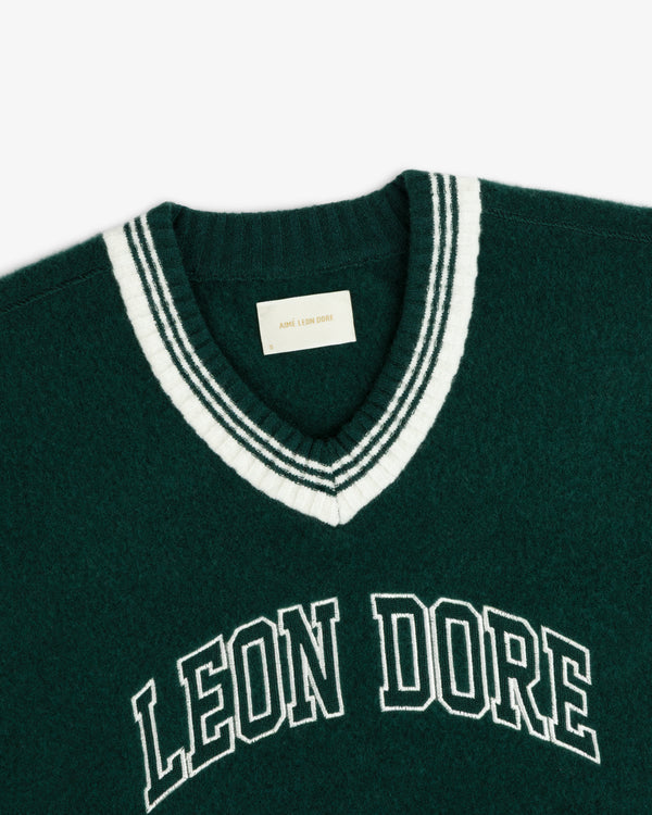 Boiled Wool Letterman sweater in dark green with white striped V-neck trim and LEON DORE embroidered on the chest.