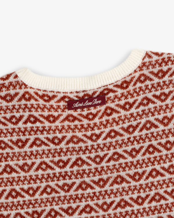 Wool Cashmere Jacquard Shell sleeveless sweater with a cream ribbed neckline and rust-colored geometric pattern.