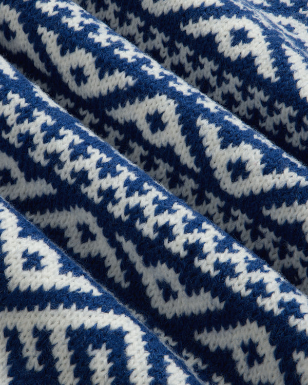Close-up of the blue and white geometric knit fabric of the Poros Jacquard Pullover.
