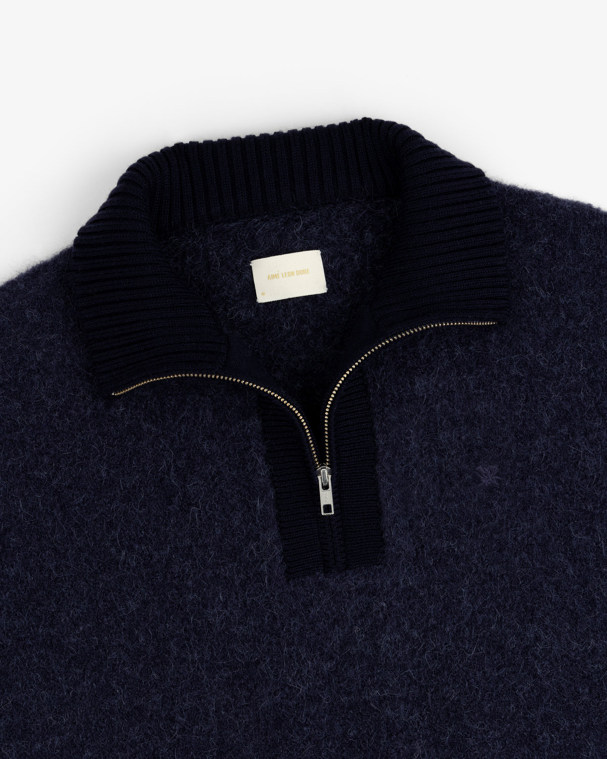 Alpaca Wool Quarter Zip Sweater in navy with ribbed collar and visible zip, shown flat on a white background.
