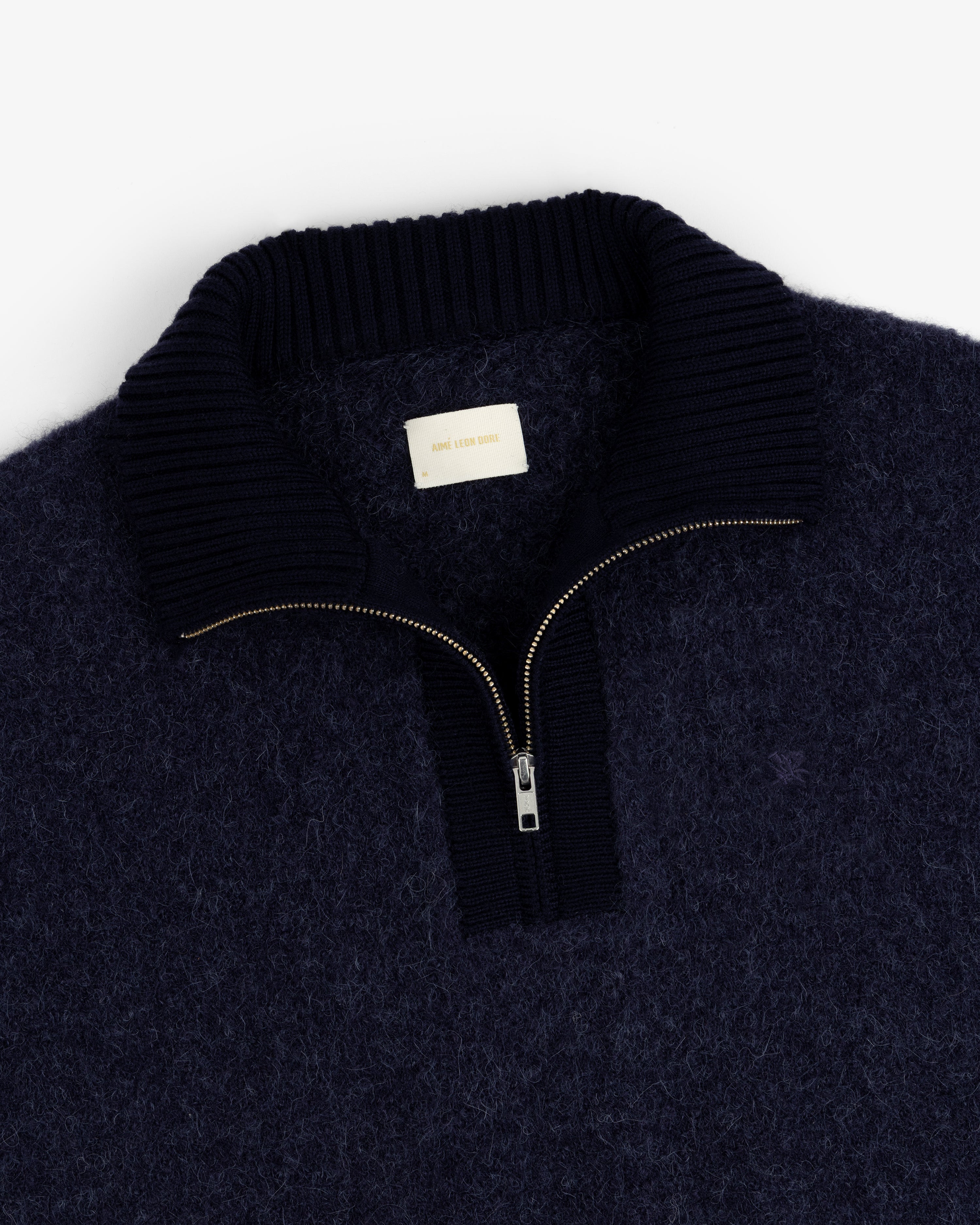 Alpaca Wool Quarter Zip Sweater in navy with ribbed collar and visible zip, shown flat on a white background.