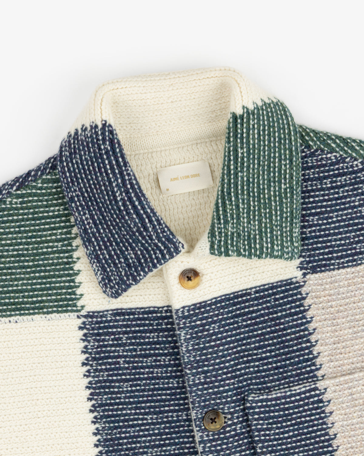 Patchwork Knit Chore Jacket featuring a cream, green, and blue knit pattern with a collared neckline and button front.