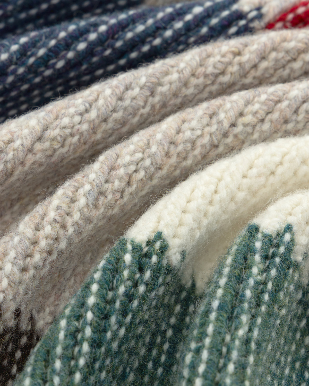 Close-up of the Patchwork Knit Chore Jacket showing thick, multicolored knit fabric with textured stripes.
