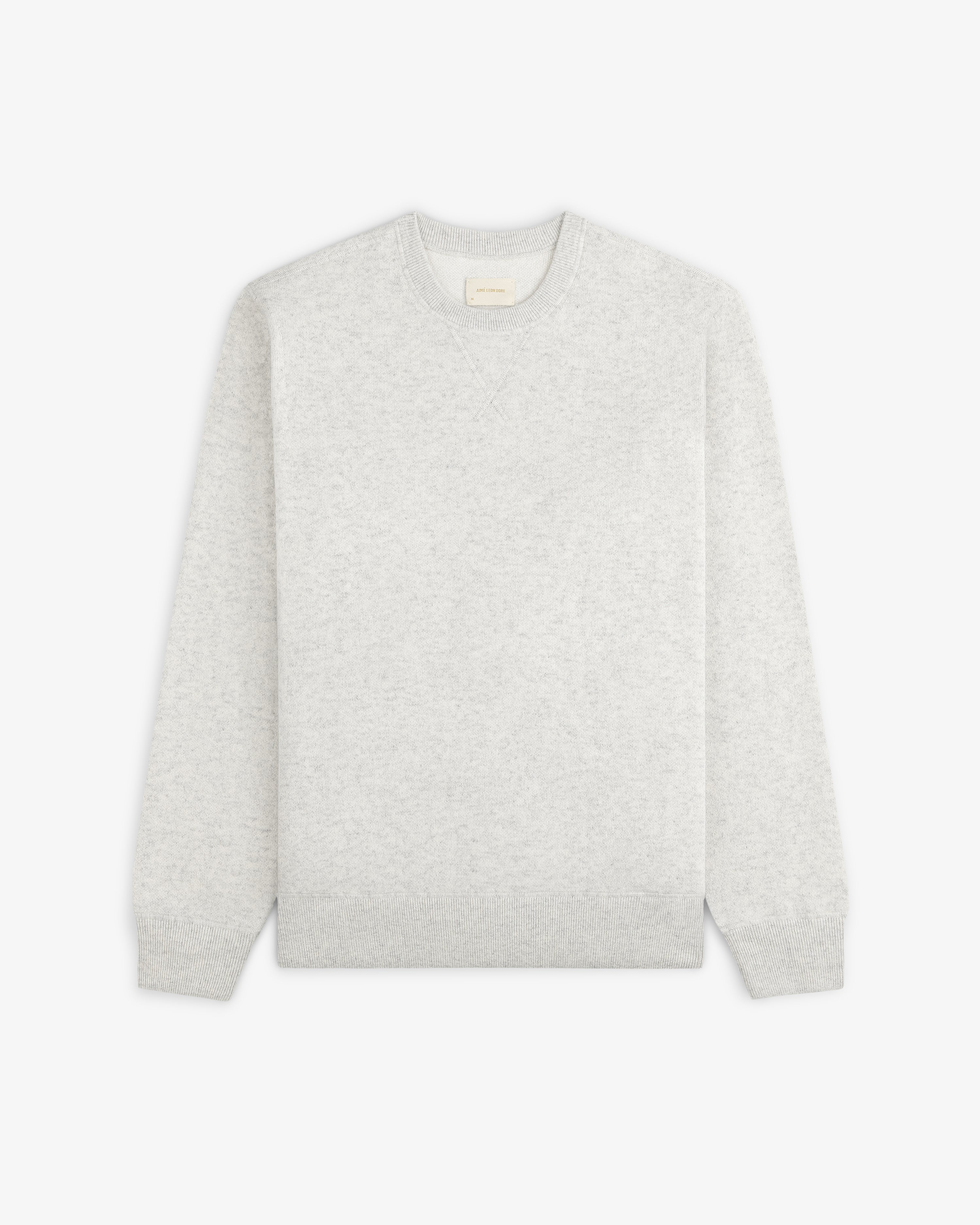 Pavilion Cashmere Crewneck Sweatshirt in light gray, with long sleeves, laid flat on a white background.