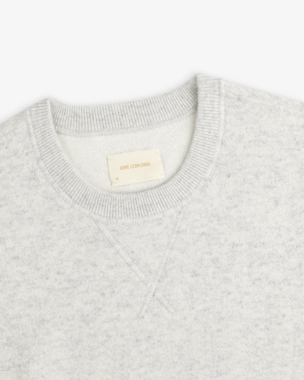 Light gray Pavilion Cashmere Crewneck Sweatshirt with ribbed collar and inside Aime Leon Dore tag.