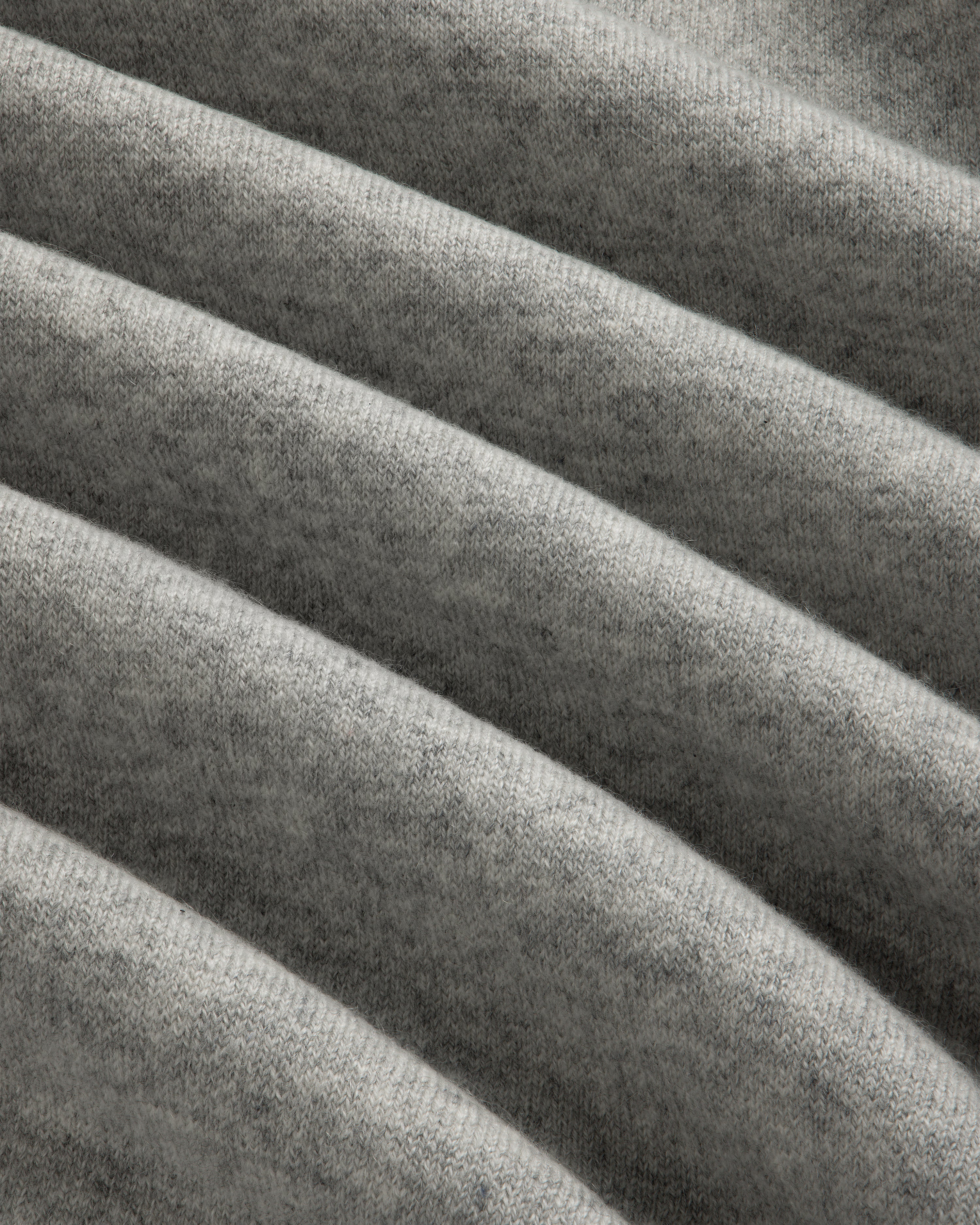Close-up of Pavilion Cashmere Crewneck Sweatshirt in grey, showing its soft ribbed fabric and horizontal texture.