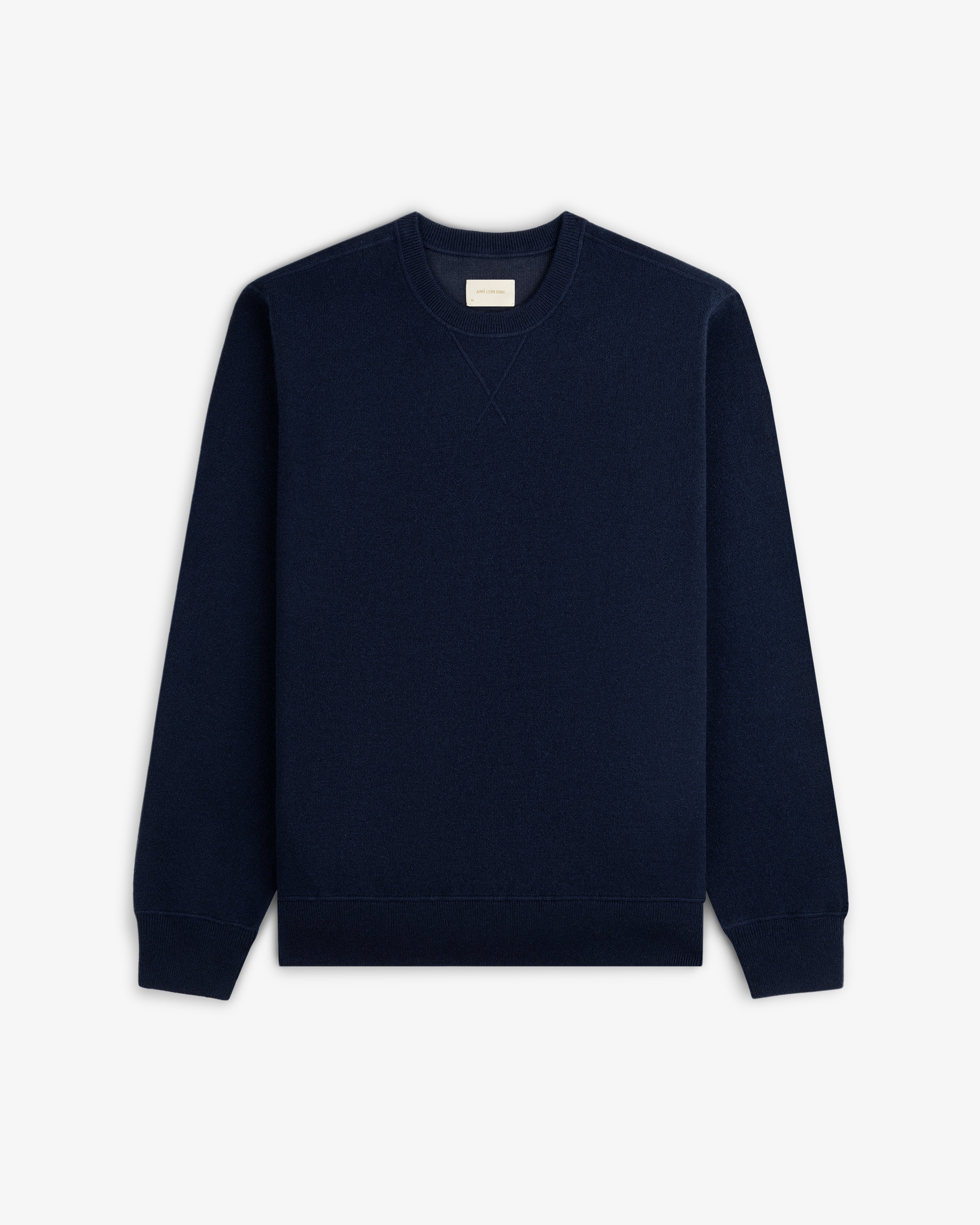 Pavilion Cashmere Crewneck Sweatshirt in navy blue, flat on white, with long sleeves and ribbed cuffs visible.